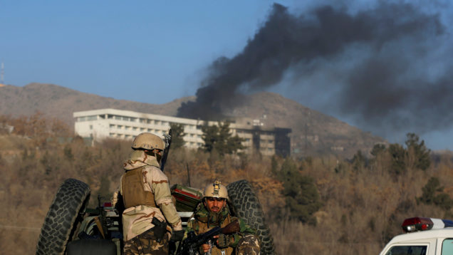 FILE PHOTO: Afghan security forces keep watch as smoke rises from the Intercontinental Hotel in Kabul, Afghanistan