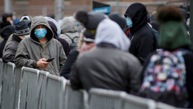 People wait in line to be tested for coronavirus disease (COVID-19) outside Elmhurst Hospital Center in the Queens borough of New York