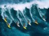 Seven surfers riding large wave, Hawaii, USA, aerial view