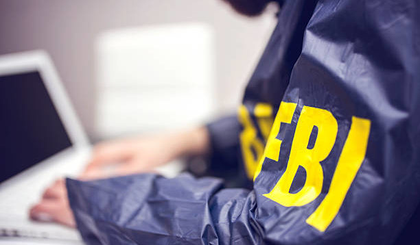 FBI agent working on his computer in office